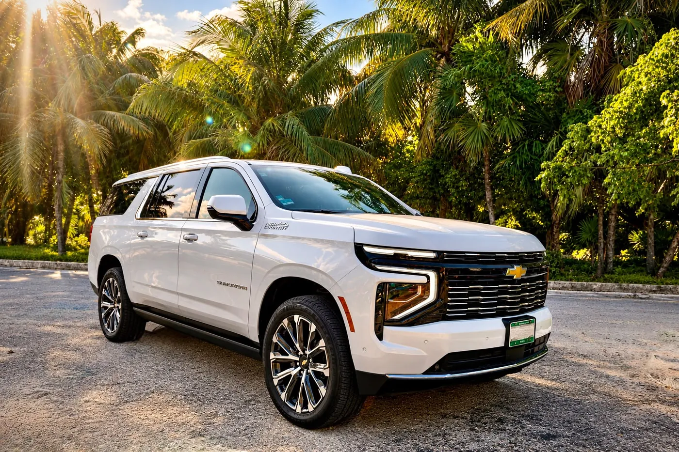 White Chevrolet Suburban High Country among palm trees in Cancun